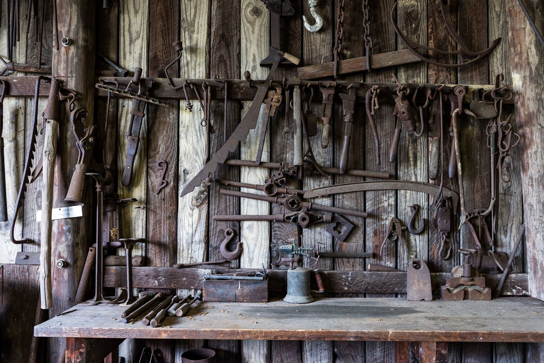 A vintage workshop wall hung with the hand tools of a lifetime in the trade