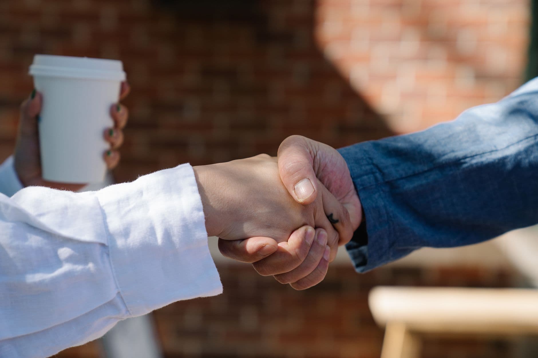 Two people shaking hands on an agreement